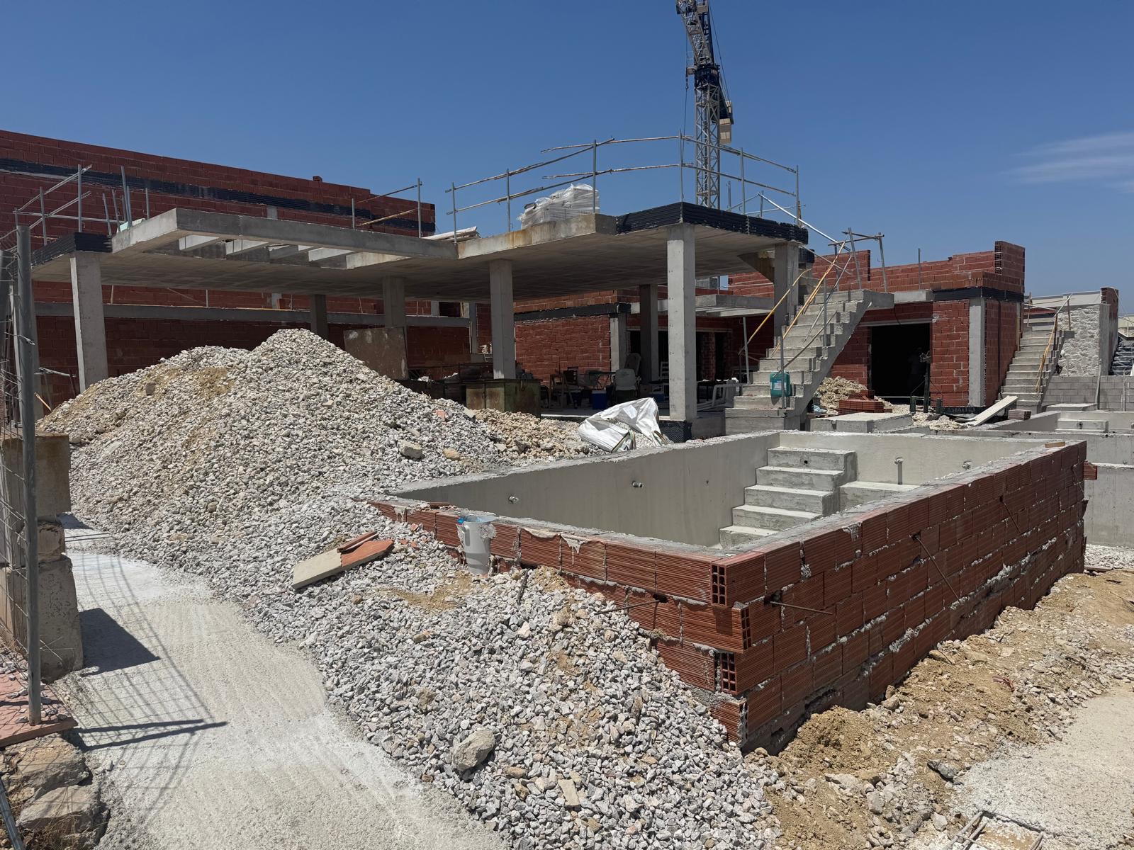 Construction site with crane and concrete staircase