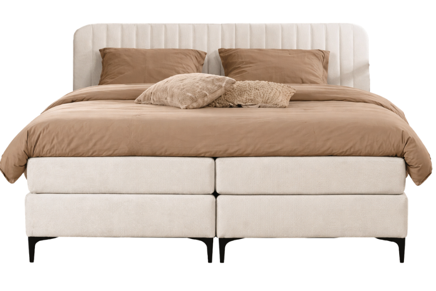 Second bedroom — cream upholstered boxspring with caramel linen and bouclé throws